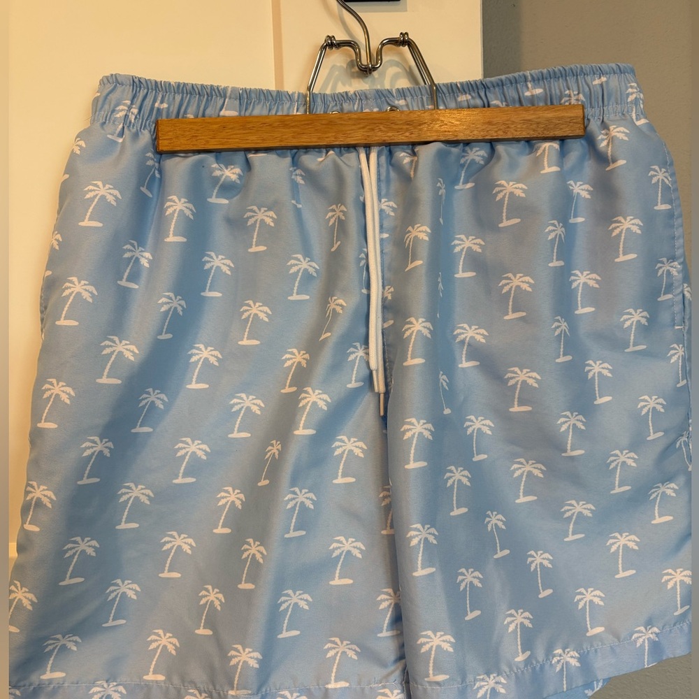 SHEIN Light blue and white palm tree men’s swim trunks